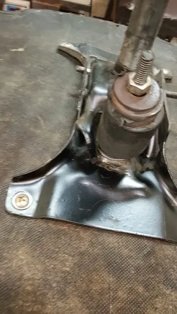 Office chair hydraulic mechanism being repaired