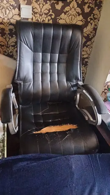 Torn executive chair before repair