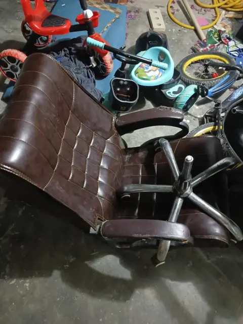 Brown executive chair needing repair