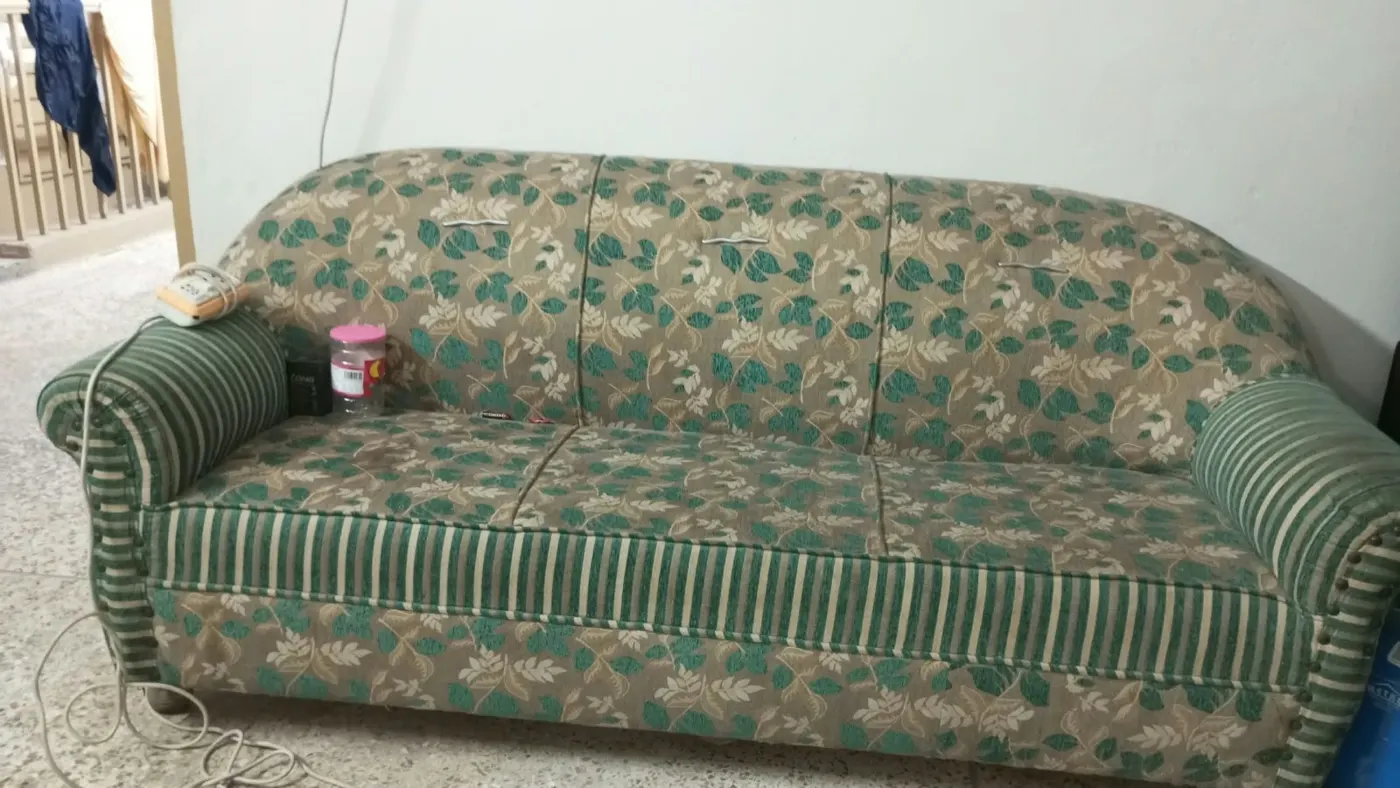 Sofa before, in faded green fabric