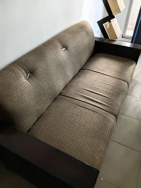 Brown fabric sofa repaired