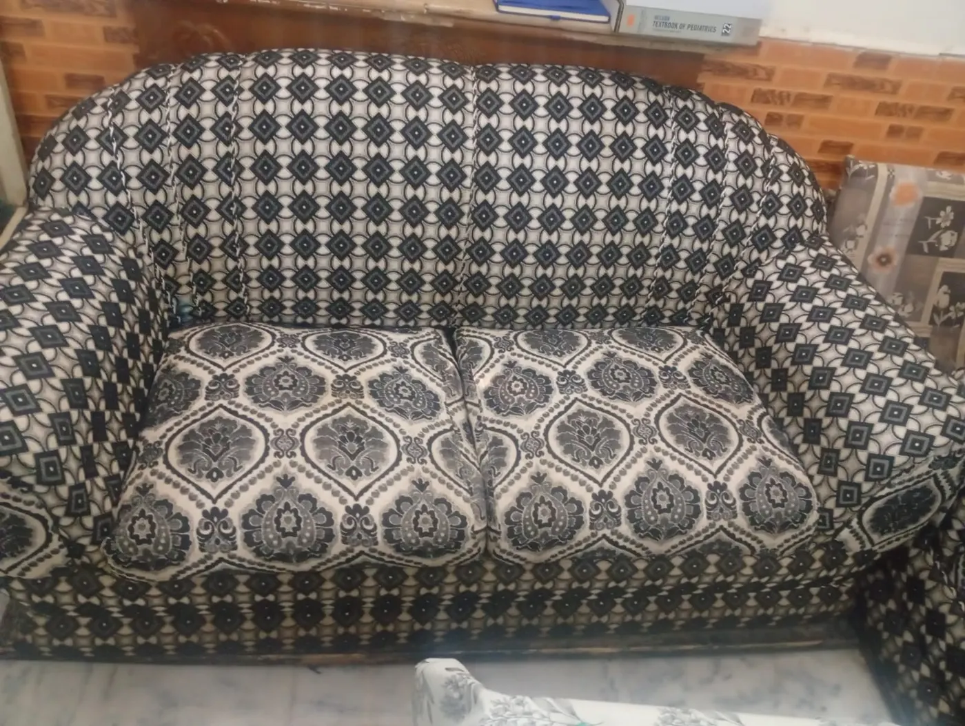 Sofa re-upholstered in black and cream jacquard fabric