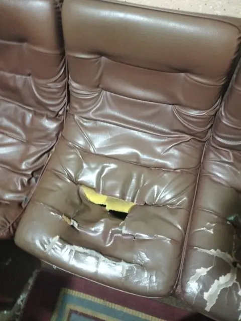 Torn and peeling leather sofa before repair